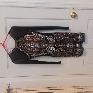 Dress with sequin detail and sheer sleeves.